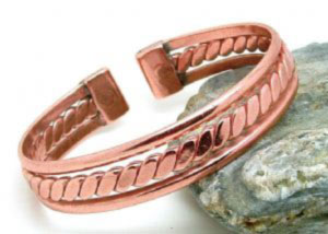 A copper bracelet with a copper twisted, flattened centre. Each tab end is fitted with a rare earth magnet
