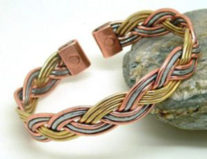 A traditional Celtic plait design made from copper, brass and enough aluminum to give a three colour look. Each end is fitted with rare earth magnets
