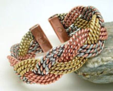 A three colour Celtic plait design made from twists of copper, brass and aluminum plaited together to form a 20mm wide heavy three colour bracelet. Each tab-end is fitted with a rare earth magnet